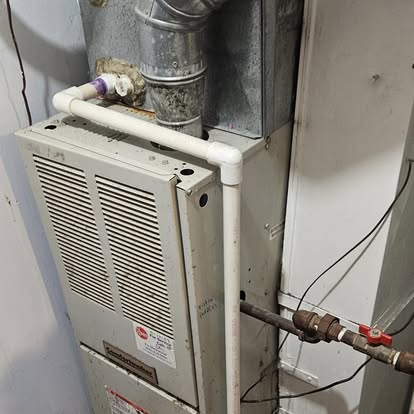 A newly installed Rheem furnace with new venting and refrigerant-line connections